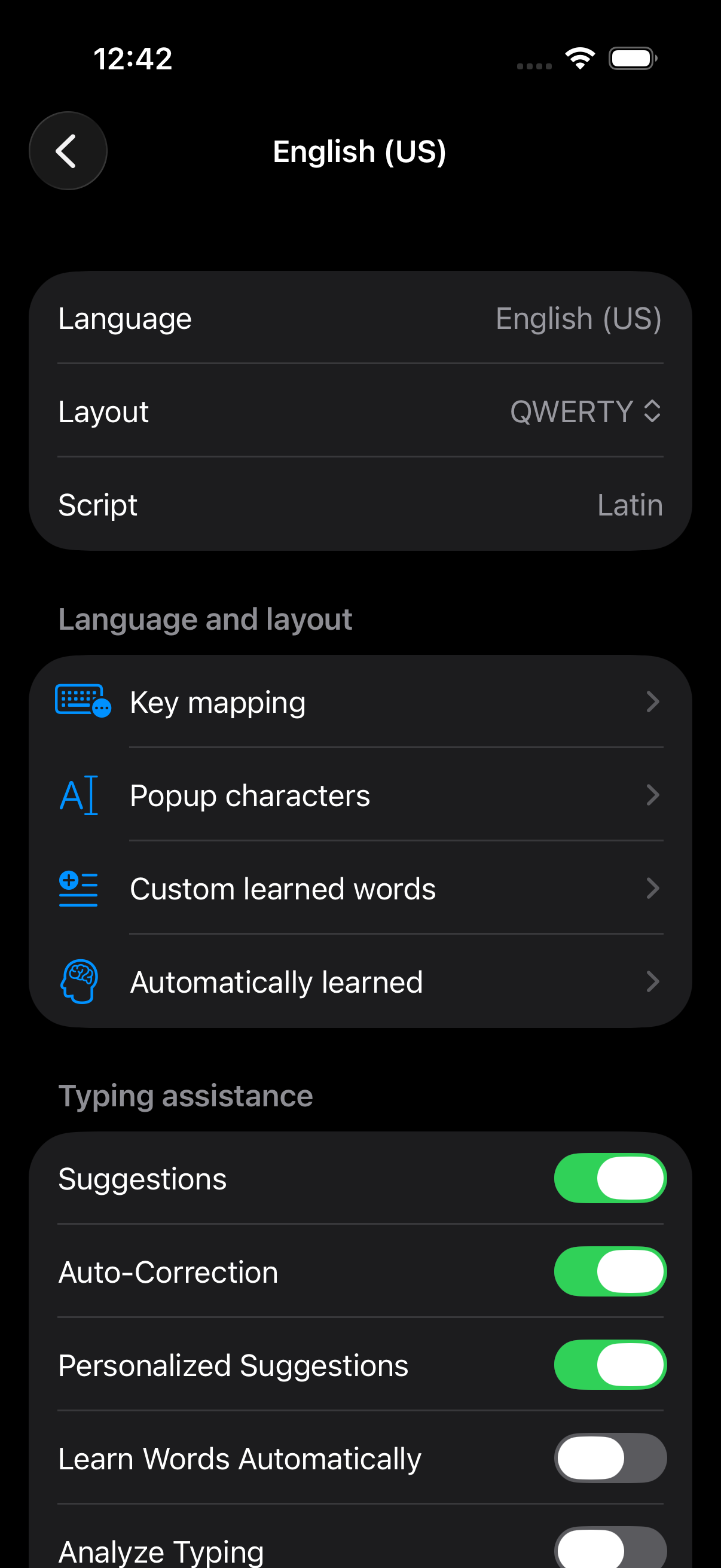 English US settings showing layout, learned words, and typing assistance controls